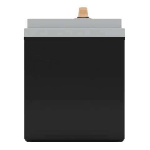 A black and gray rectangular object with a tan knob on top, likely an electronic or industrial device.