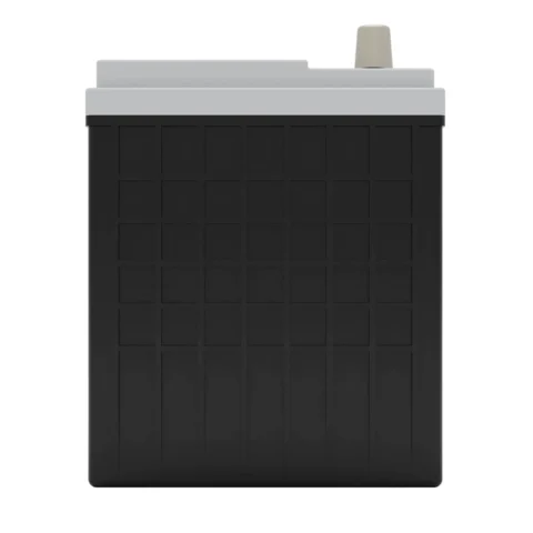 A large black and gray industrial battery with a grid pattern on the front and a protruding terminal on top.