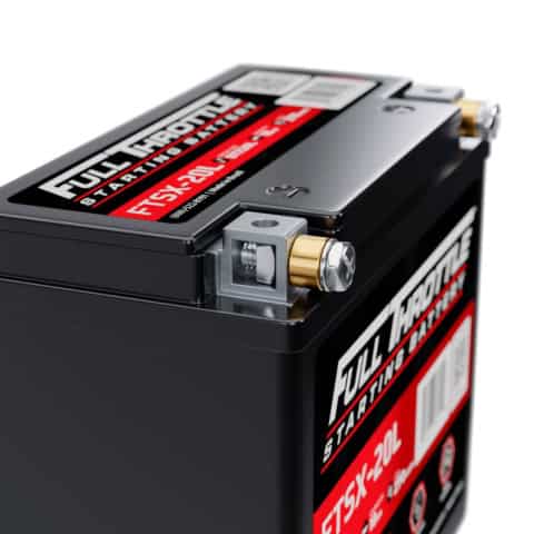 Close-up of a Full Throttle FTSX-30L starting battery, featuring visible terminals and labels with product details.