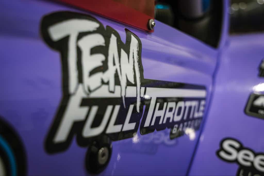A purple car with the words team full throttle on it.