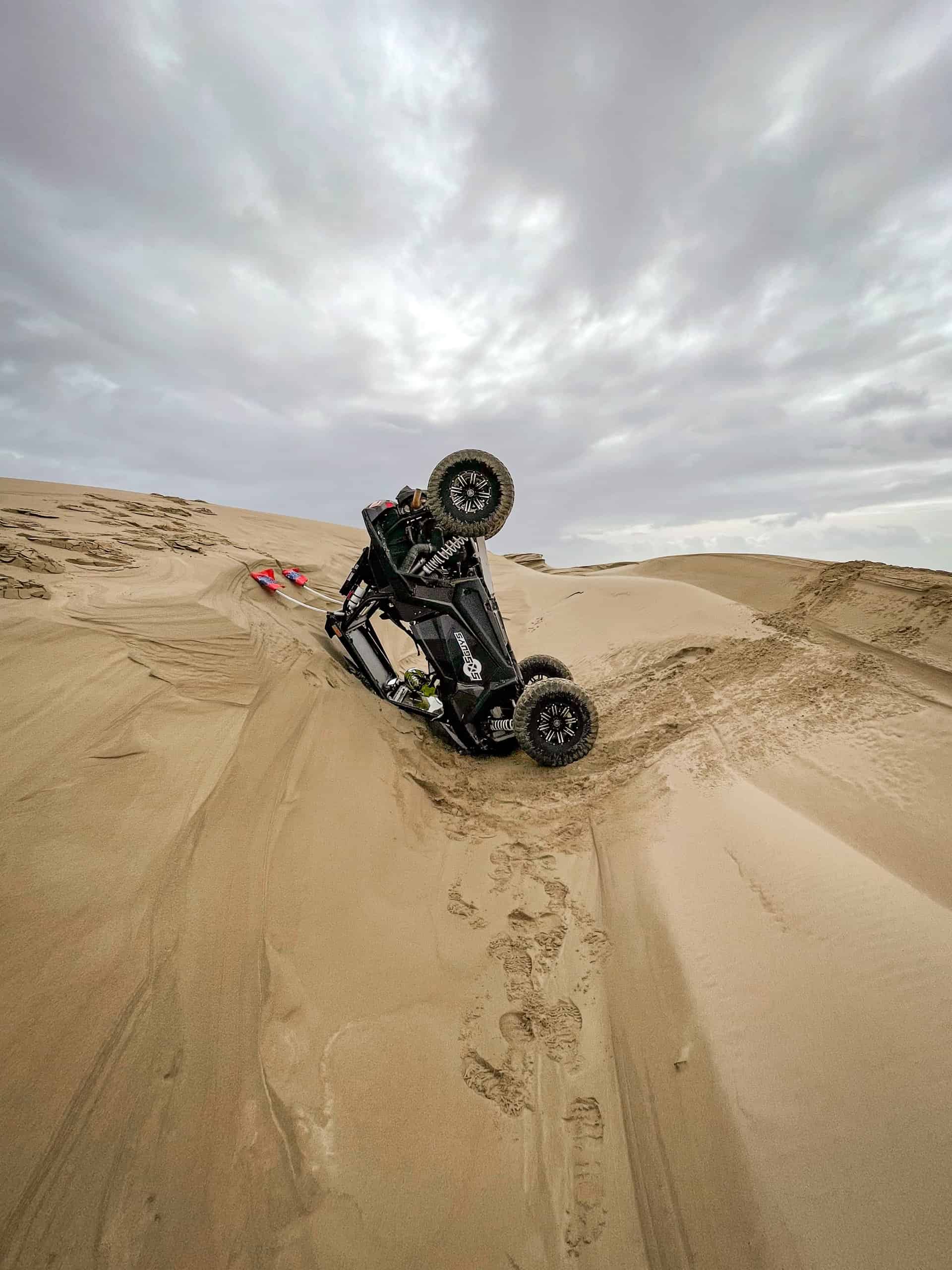 A quad bike on a sand dune in the desert.