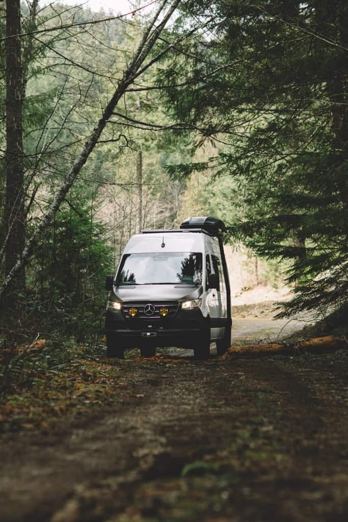 Cameron's van parked on a dirt road in the woods.