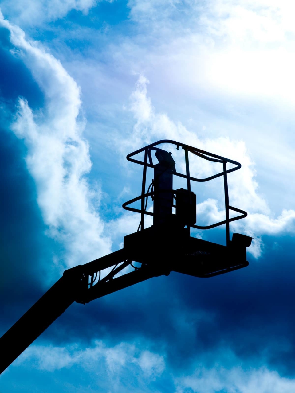 Silhouette of an aerial work platform