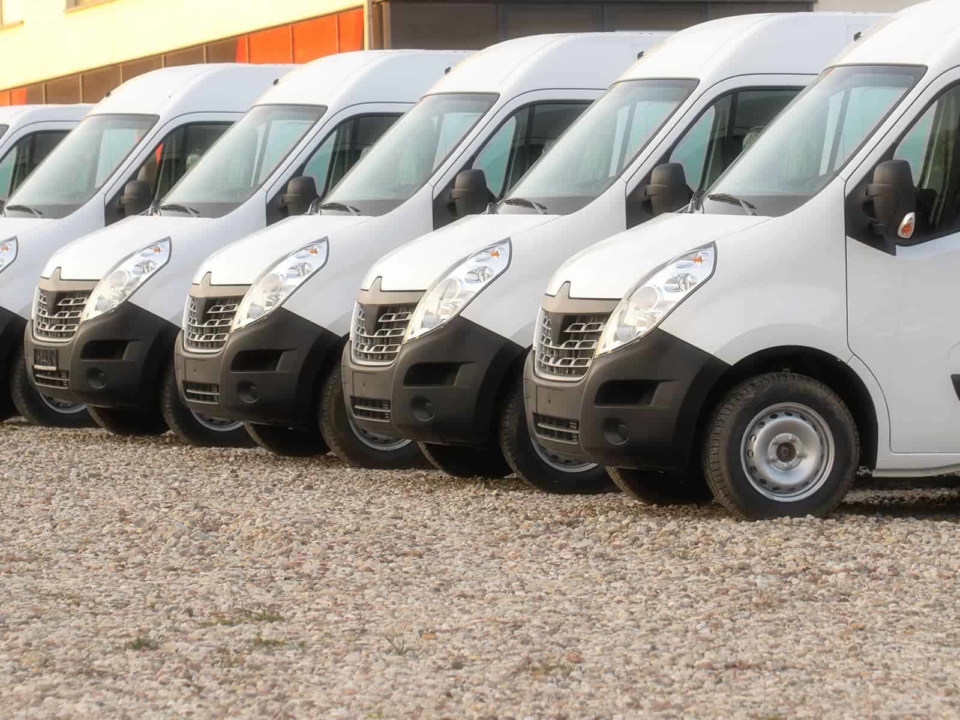Fleet of delivery vans in a parking lot