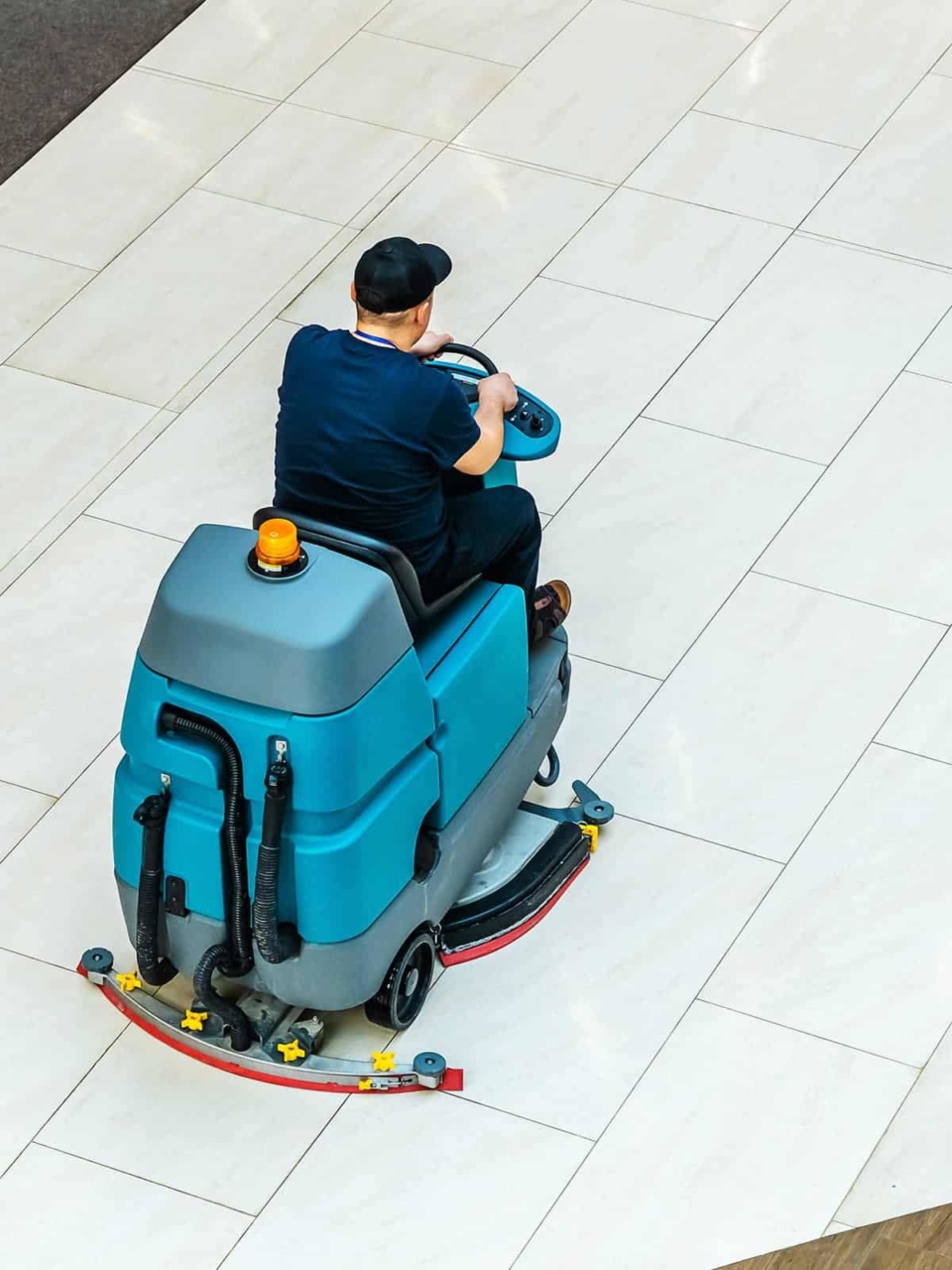 Man riding floor care machine