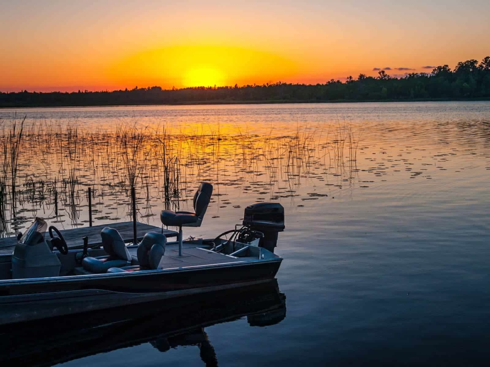 Bass fishing boat on the water at sunset