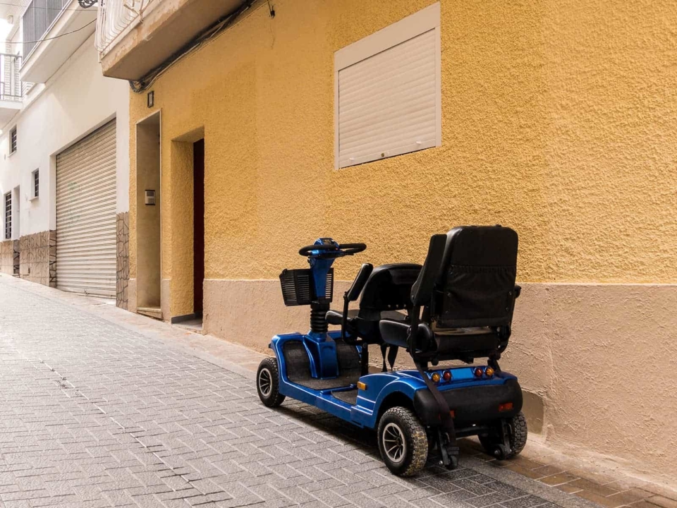 A mobility scooter parked near a building