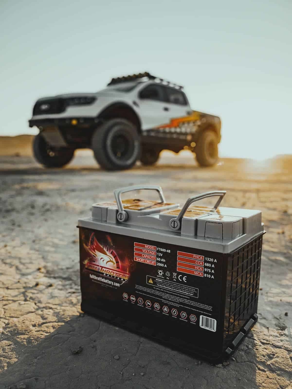 Custom retro wrapped F-150 in the desert with a Full Throttle battery in the foreground