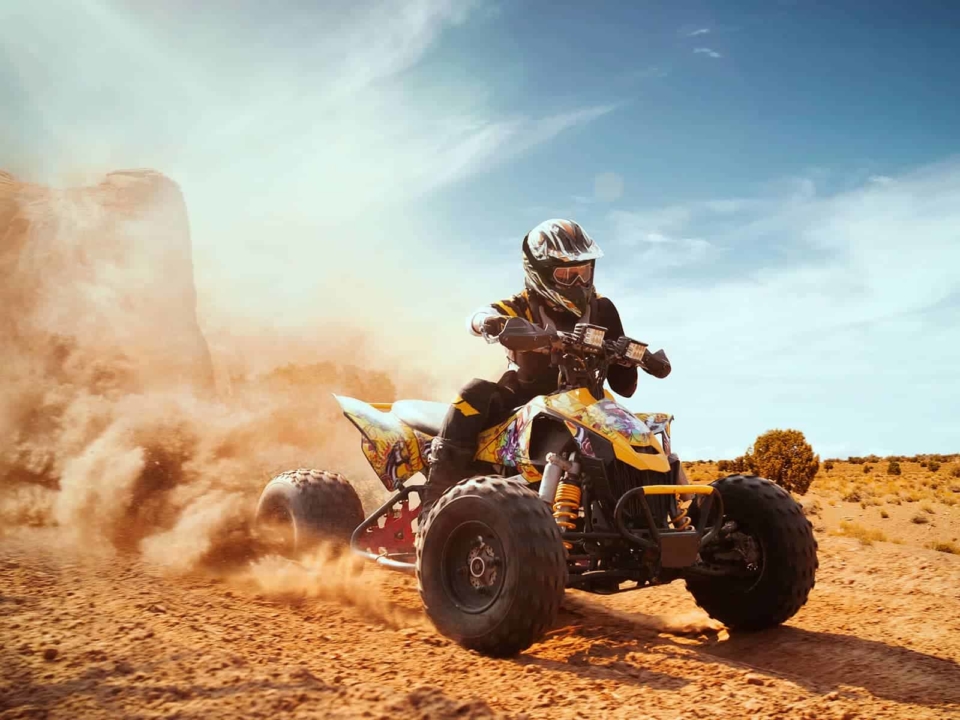 A man riding a quad in the desert