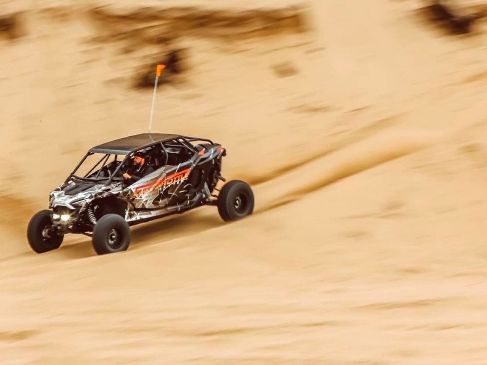Full Throttle UTV driving down a sand dune